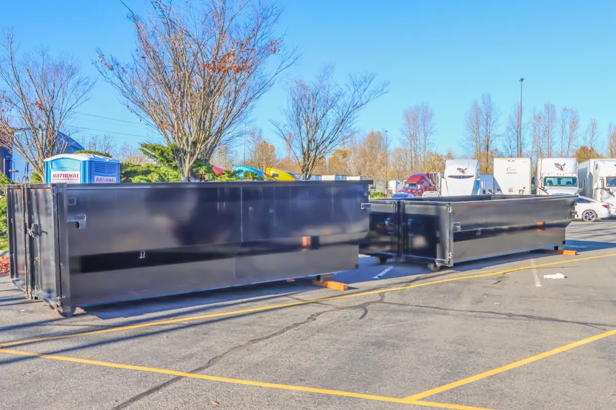 Professional dumpster rental service with roll-off container on residential driveway in Laguna Niguel